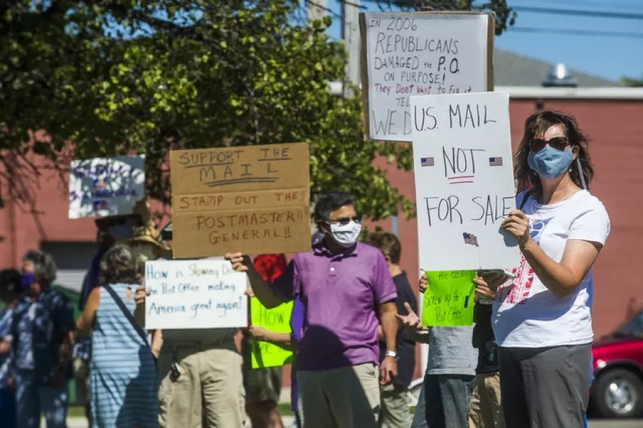 People in Michigan protesting about funds for the US Postal Service being withheld (Katy Kildee/Midland Daily News via AP)