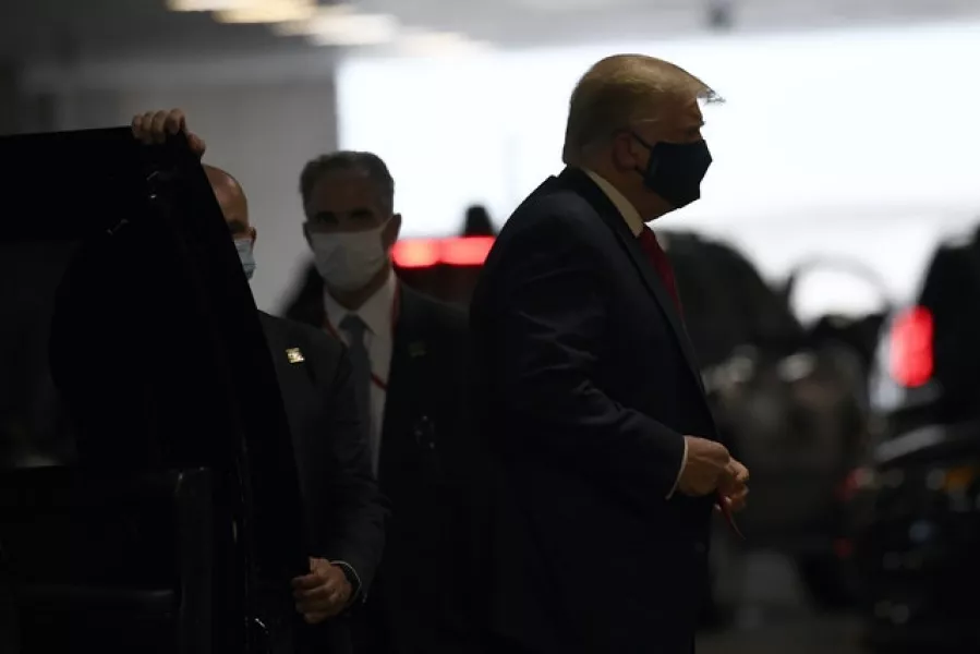 Donald Trump steps out of his vehicle in New York on his way to visit his younger brother (Susan Walsh/AP)