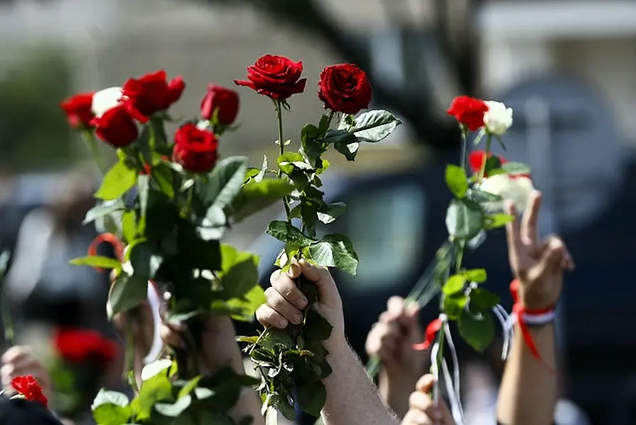 People wave flowers at the farewell hall during the funeral of Alexander Taraikovsky (Seregi Grits/AP)