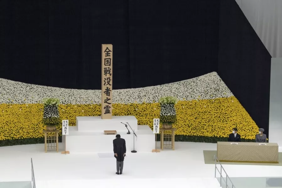 Japanese PM Shinzo Abe bows watched by Emperor Naruhito and Empress Masako as they attend the memorial service. Photo: Carl Court/Pool Photo via AP