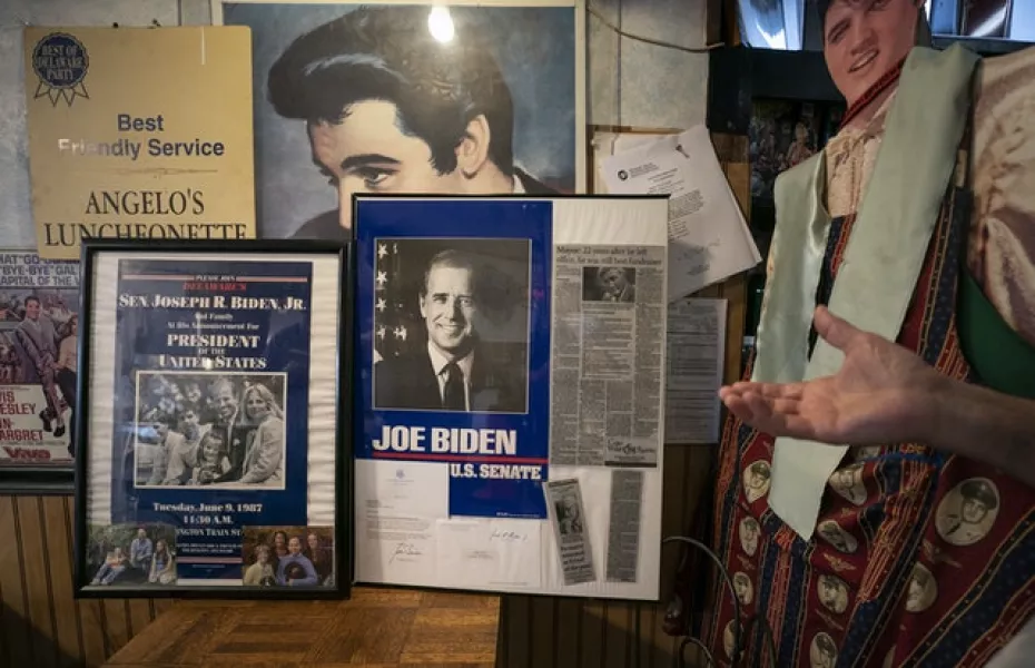 August Muzzi, owner of Angelo’s Luncheonette, gestures to some of his Joe Biden memorabilia displayed in Wilmington, Delaware (Carolyn Kaster/AP)