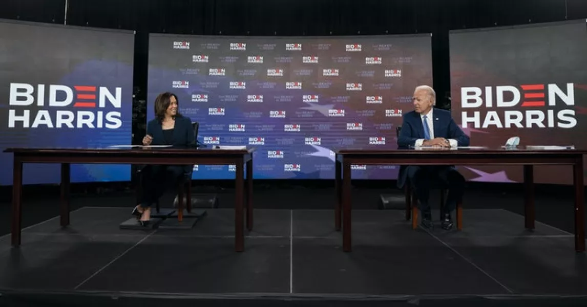 Democratic presidential candidate former Vice President Joe Biden and running mate Senator Kamala Harris look to each other as they sign documents (Carolyn Kaster/PA)