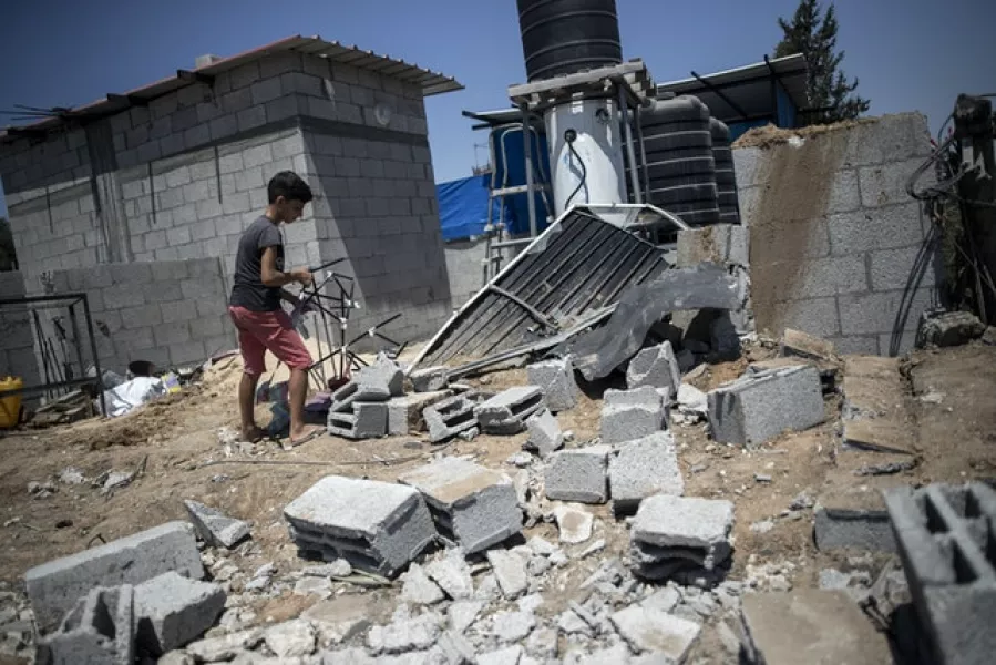 Damage in the Buriej refugee camp in the central Gaza Strip (Khalil Hamra/AP)