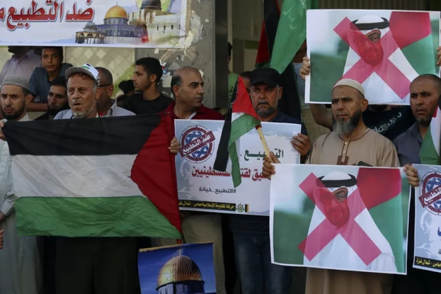 Hamas supporters hold pictures showing Abu Dhabi Crown Prince Mohamed bin Zayed al-Nahyan during a protest against the United Arab Emirates’ deal with Israel (Adel Hana/AP)