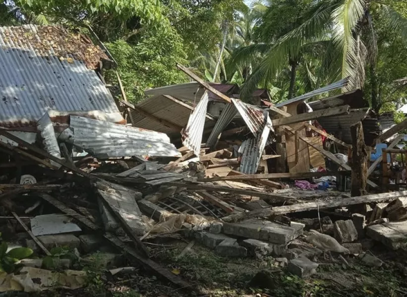 A toppled house is seen after a quake struck in Cataingan, Masbate province, central Philippines (John Mark Lalaguna/Philippines Red Cross/AP)