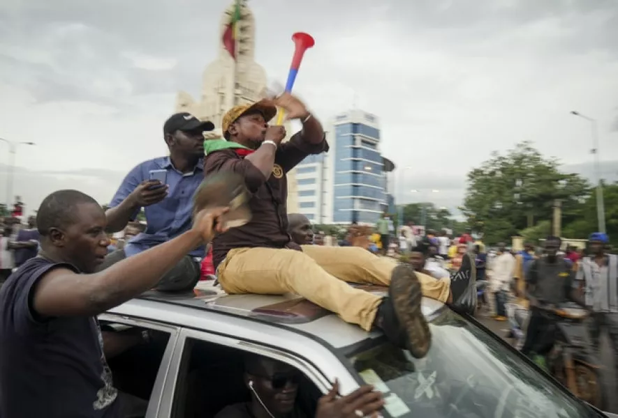 People celebrate in the streets in the capital Bamako, Mali (AP)