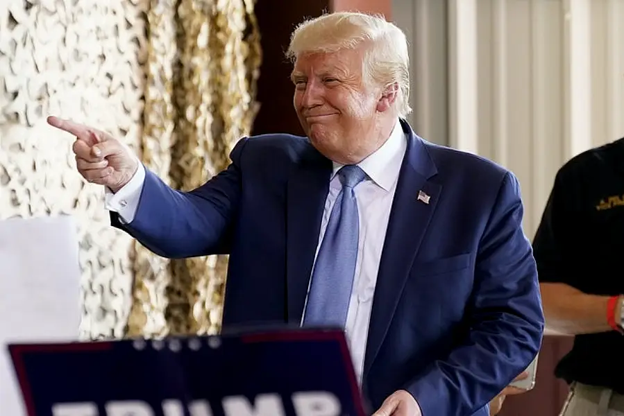 President Donald Trump points to supporters after speaking at Yuma International Airport in Arizona (Matt York/AP)