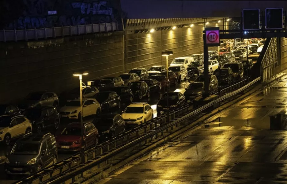 Vehicles parked on the closed motorway following the incident (Paul Zinken/dpa via AP)