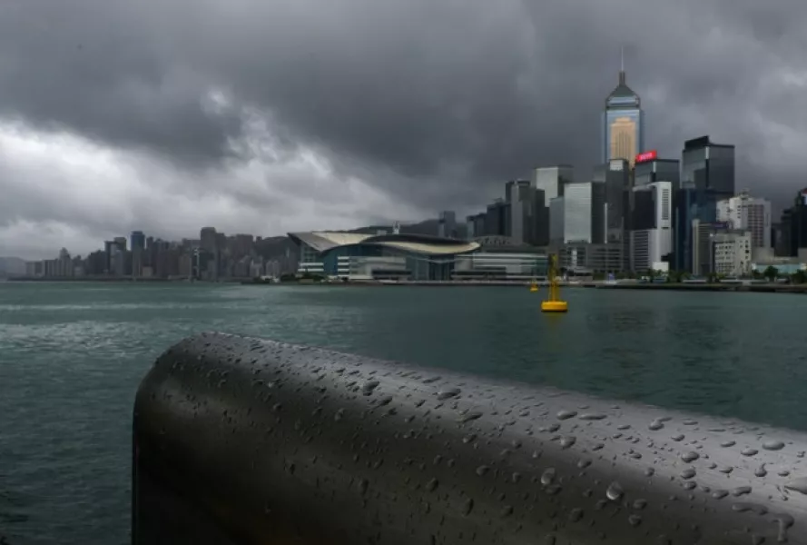 Rain droplets line a railing along the waterfront of Victoria Harbour in Hong Kong (Vincent Yu/AP)