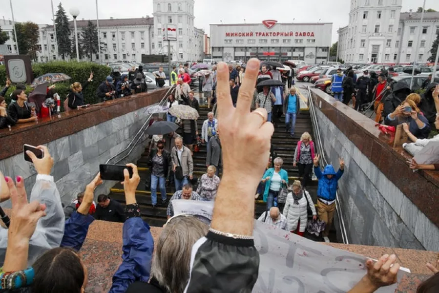 Protesters gather in front of the Minsk Tractor Works Plant to support workers leaving the plant after their shift (Dmitri Lovetsky/AP)