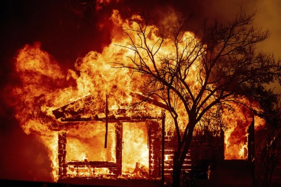 A home is engulfed by the flames (AP)