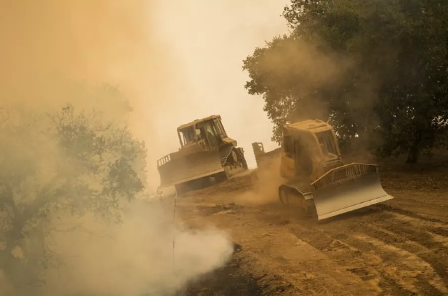Bulldozers create a fire break on Buck Mountain to fight the Carmel Fire near Carmel Valley (AP)