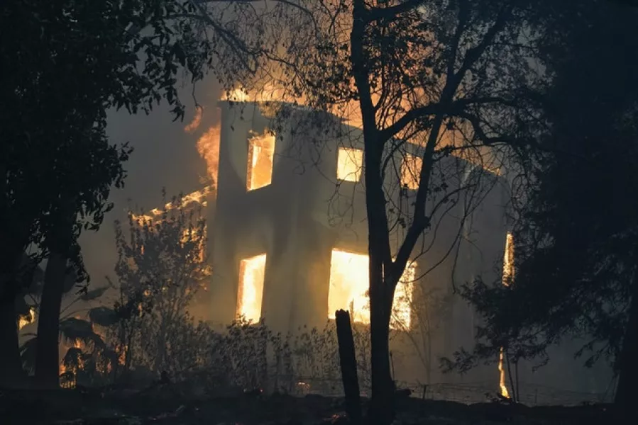 A home burns in Bonny Doon, California (Marcio Jose Sanchez/AP)
