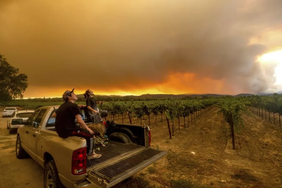 Thomas Henney, right, and Charles Chavira watch a plume spread over Healdsburg, California (Noah Berger/AP)