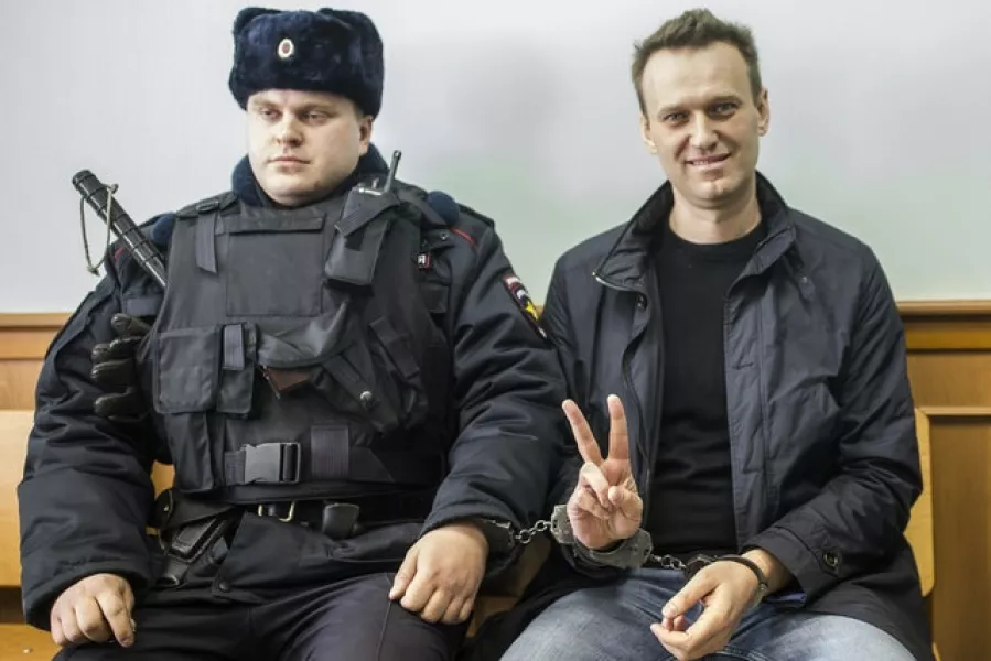 Alexei Navalny shows a V-sign for the media in court in Moscow in 2017 (Evgeny Feldman/AP)