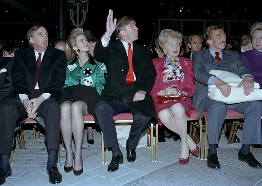 Donald Trump waves to staff members of the Trump Taj Mahal Casino Resort as they cheer him on before the grand opening ceremonies in Atlantic City, New Jersey. He attended the gala with his mother, Mary; father, Fred; and sister, US District Court Judge Maryanne Trump Barry, right. On the left are Donald Trump’s brother Robert Trump and his wife, Blaine Trump (Charles Rex Arbogast/AP)