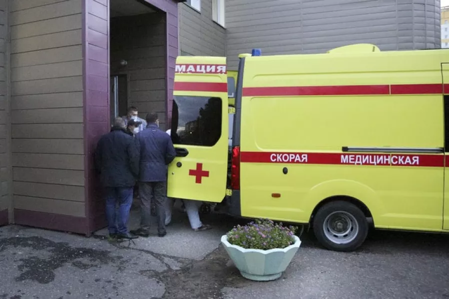 Medics carry Alexei Navalny into an ambulance at the Omsk Ambulance Hospital No 1 (Evgeniy Sofiychuk/AP)