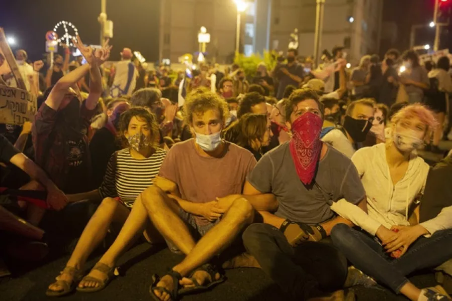 Thousands have protested against Mr Netanyahu’s handling of the country’s coronavirus crisis (Maya Alleruzzo/AP)