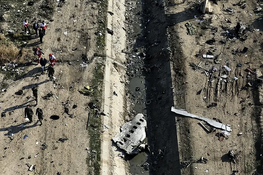 Rescue workers search the scene where the Ukrainian plane was shot down in Shahedshahr, southwest of Tehran, Iran (Ebrahim Noroozi/AP)