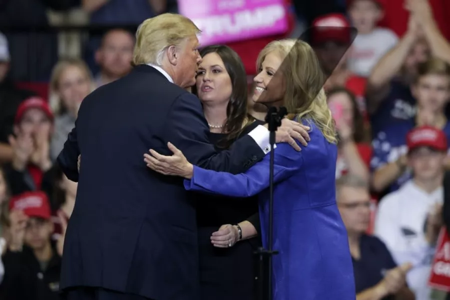 Donald Trump greets then-press secretary Sarah Huckabee Sanders and White House senior adviser Kellyanne Conway at a previous campaign rally. Photo: AP