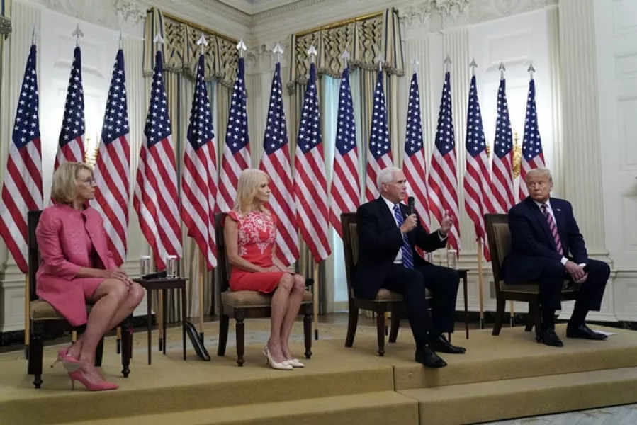 Ms Conway, sitting next to Donald Trump and Mike Pence at a White House event. Photo: AP