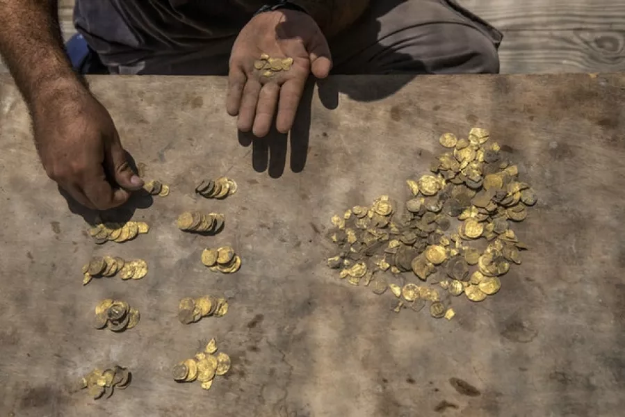 The collection of 425 complete gold coins mostly date back to the Abbasid period around 1,100 years ago (AP/Sipa Press, Heidi Levine, Pool)