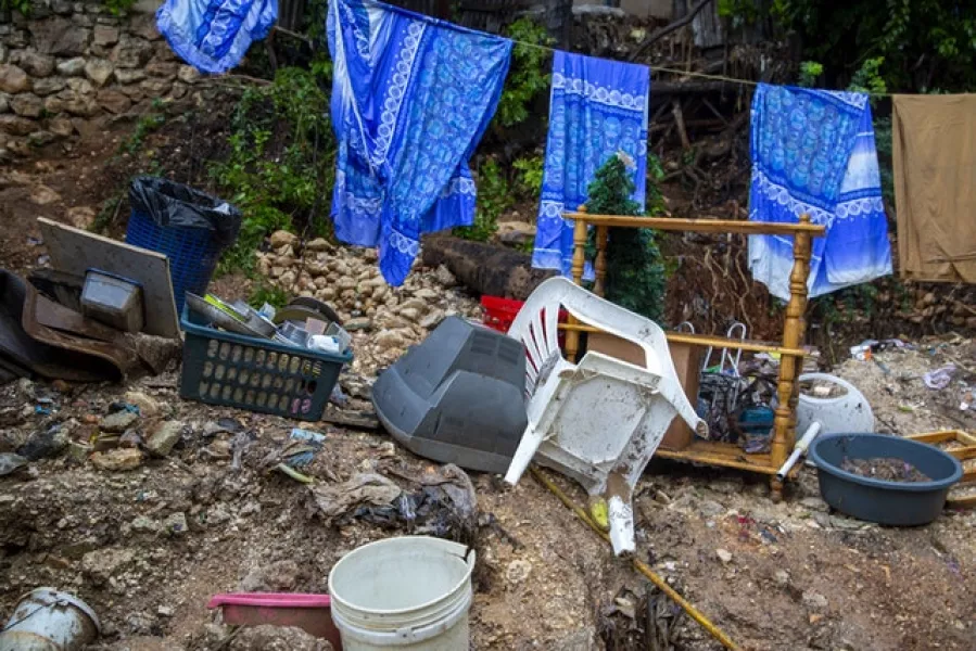 Salvaged items stand next to a damaged house near a river after the passing of tropical storm Laura in Port-au-Prince, Haiti (AP/Dieu Nalio Chery)