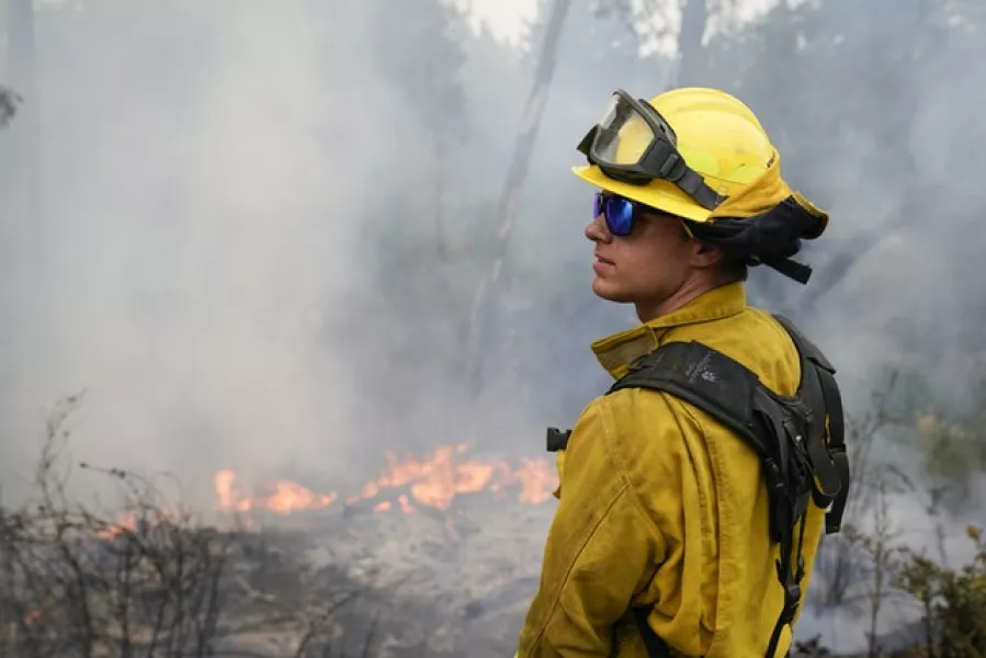 Firefighter Cody Nordstrom monitors hot spots while fighting the CZU Lightning Complex Fire (Marcio Jose Sanchez/AP)