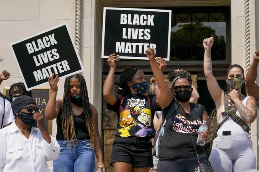 Protesters hold up Black Lives Matter signs (Morry Gash/AP)