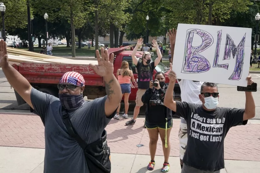 A group of Black Lives Matter protesters hold a rally on the steps of the Kenosha County courthouse (Morry Gash/AP)