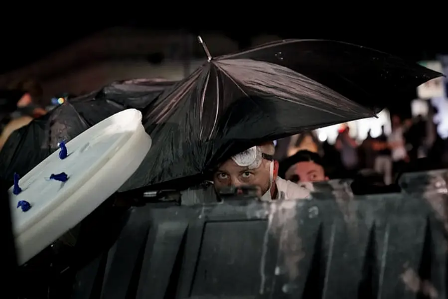 A protester takes cover (AP)