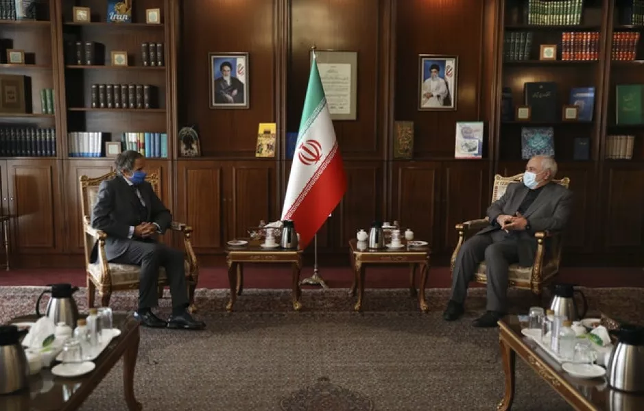 IAEA director general Rafael Mariano Grossi, left, and Iran’s foreign minister Mohammad Javad Zarif (AP/Vahid Salemi)