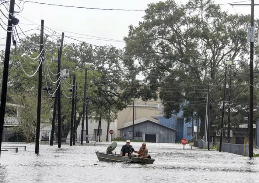 Boaters in Louisiana navigate a flooded road (Brad Bowie/The Advocate via AP)