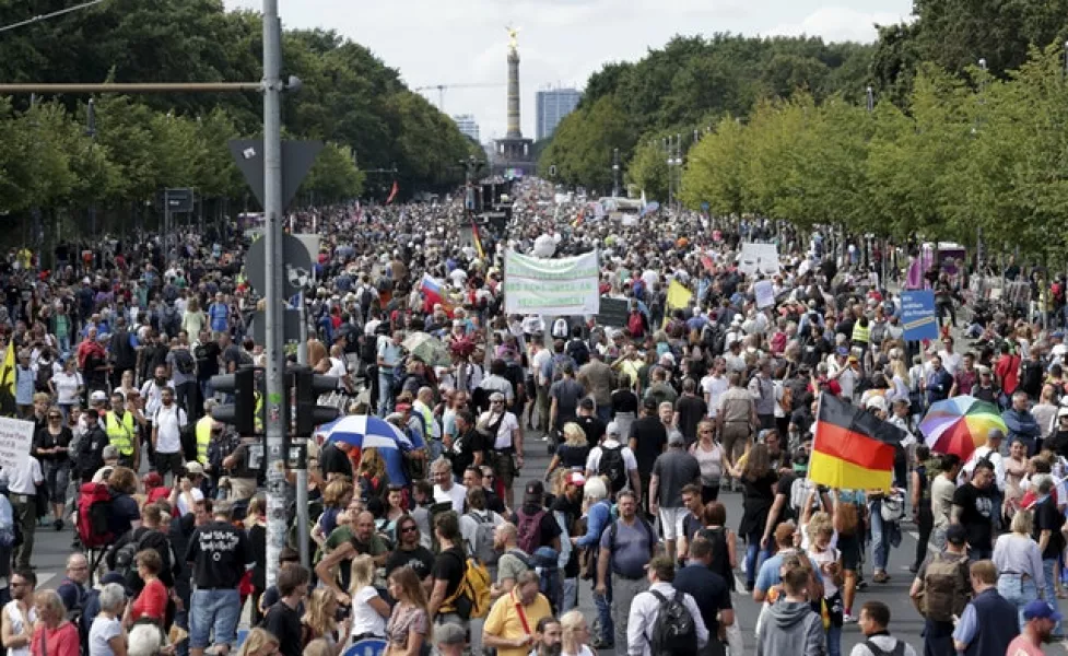 People attend a protest rally in Berlin (Michael Sohn/AP)