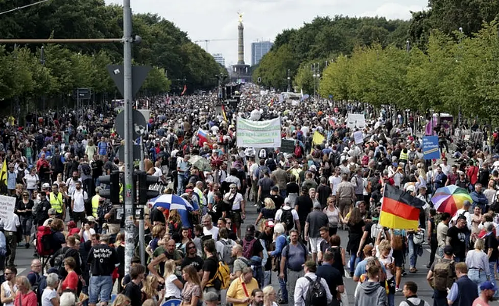 People attend a protest rally in Berlin (Michael Sohn/AP)