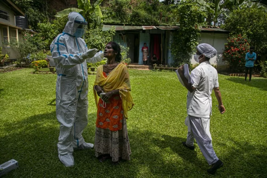 A health worker during a door-to-door test drive in Gauhati, India. Photo: Anupam Nath/AP