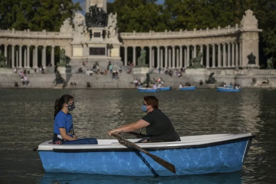 People wearing face masks at the Retiro park in Madrid, Spain. Photo: Bernat Armangue/AP