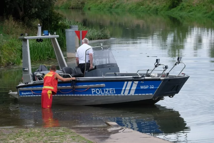 A water police boat is let into the River Unstrut in Troebsdorf, Germany (Sebastian Willnow/dpa via AP)