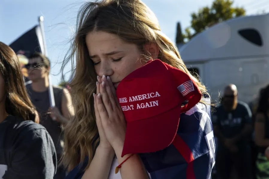 Liza Durasenko, 16, from Oregon City, prays during a rally in support of Donald Trump in Clackamas (Paula Bronstein/AP)