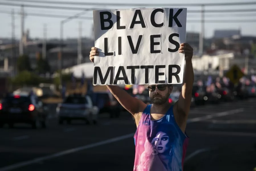 A Black Lives Matter supporter holds up a sign (Paula Bronstein/AP)