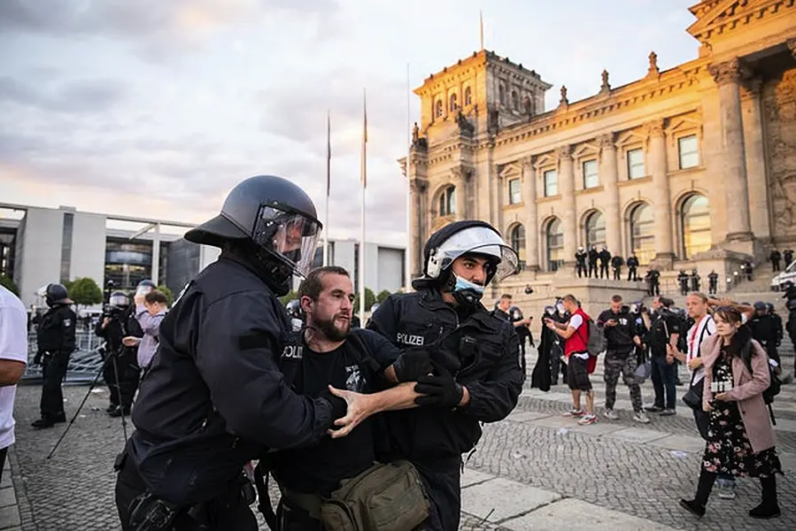 Police and demonstrators outside the Reichstag building in Berlin on Saturday (Christoph Soeder/dpa via AP)