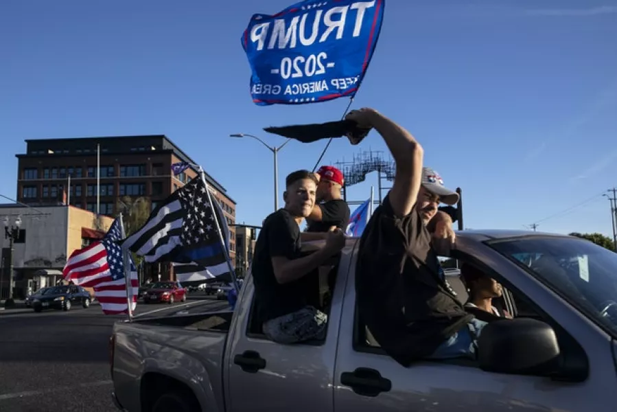 Supporters of President Donald Trump attend a rally and car parade (Paula Bronstein/AP)