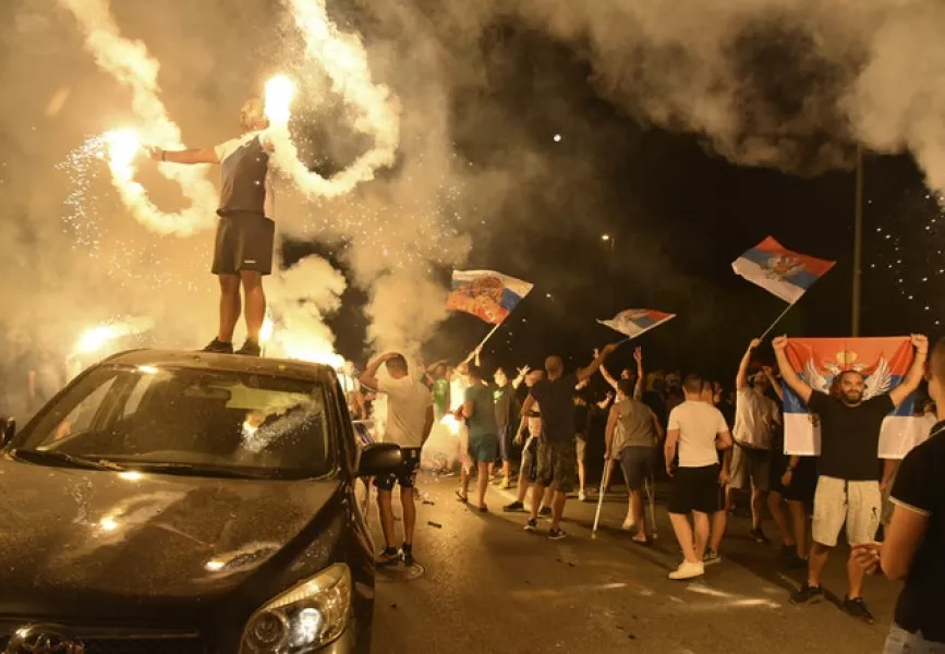 Supporters of opposition groups celebrate in Podgorica (Risto Bozovic/AP)
