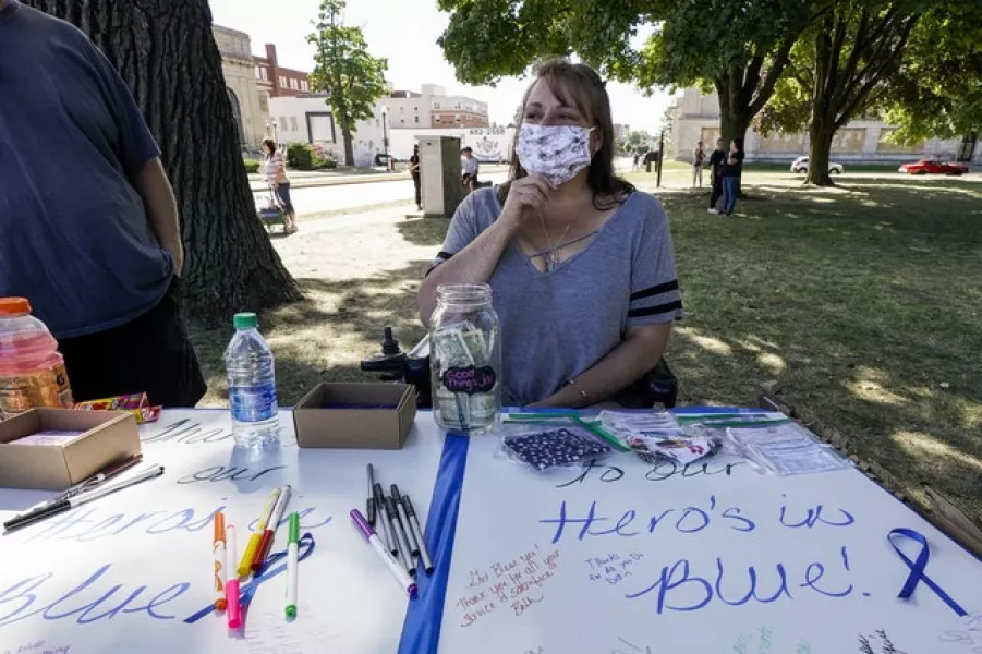 A woman makes a sign ahead of a march in support of police in Kenosha (AP/Morry Gash)
