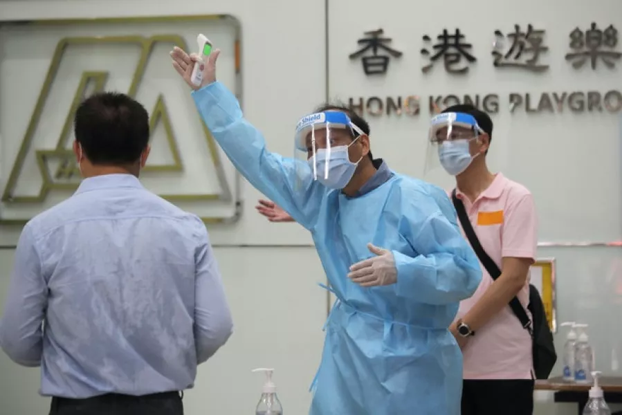 A man receives temperature check at a coronavirus testing centre (Kin Cheung/AP)