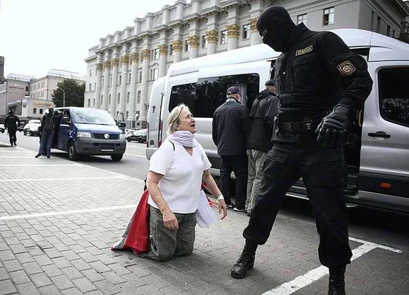 A woman argues with a policeman during a protest in Minsk (Tut.By via AP)