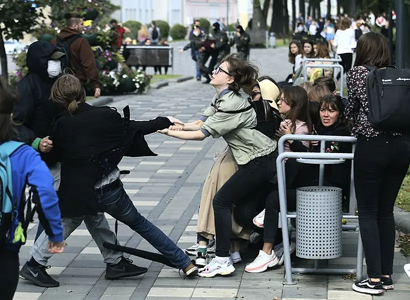 A plain-clothed policeman detains a student during a protest on Tuesday (Tut.By via AP)