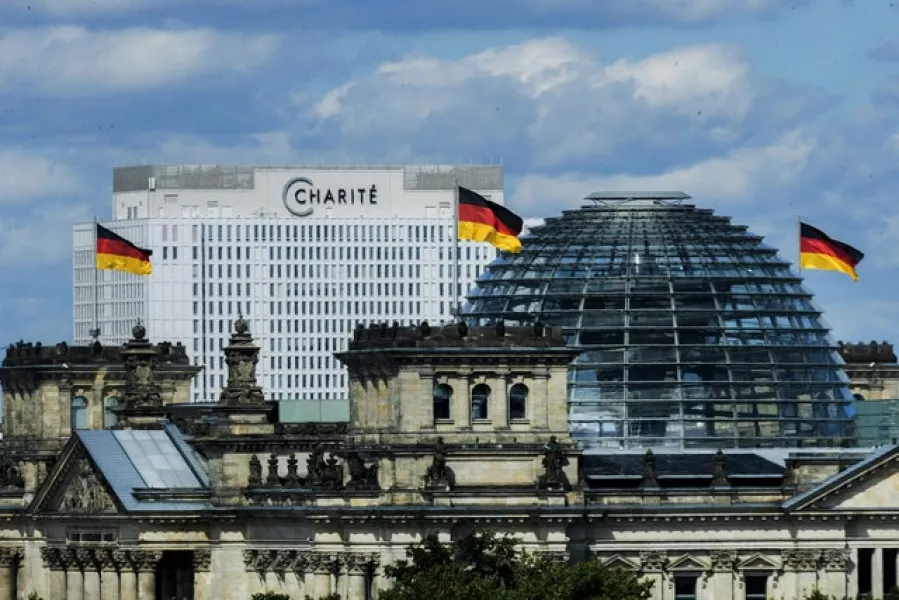Berlin’s Charite hospital can be seen behind the Reichstag (Christoph Soeder/dpa via AP)