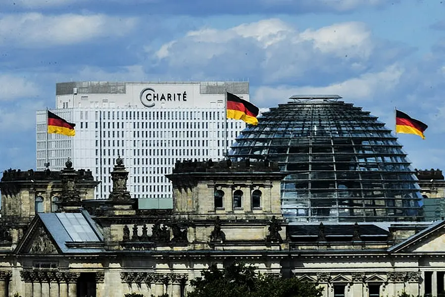 Berlin’s Charite hospital can be seen behind the Reichstag (Christoph Soeder/dpa via AP)