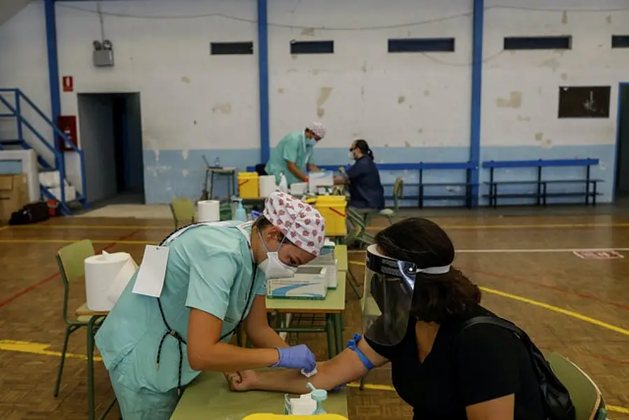 Teachers and auxiliary staff take Covid-19 tests in Madrid, Spain (Bernat Armangue/AP)